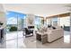 Bright and airy living room featuring floor-to-ceiling windows and modern decor at 111 Golden Gate Pt # 401, Sarasota, FL 34236