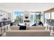 Bright living room featuring large windows, modern fireplace, and stylish contemporary furnishings at 111 Golden Gate Pt # 401, Sarasota, FL 34236