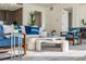 Tastefully furnished living room with stylish decor, comfortable seating, and abundant natural light at 111 Golden Gate Pt # 401, Sarasota, FL 34236