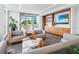 Elegant resident lounge area features comfortable seating, built-in shelving, and a serene outdoor view at 111 Golden Gate Pt # 401, Sarasota, FL 34236