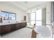 Bright, modern main bathroom features a soaking tub, glass-enclosed shower, and double vanity at 111 Golden Gate Pt # 401, Sarasota, FL 34236