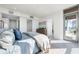 Airy main bedroom features an ensuite bath, private balcony, and stylish furnishings for a modern lifestyle at 111 Golden Gate Pt # 401, Sarasota, FL 34236