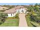 Beautiful aerial view of the home showcasing the tile roof, brick driveway and landscaping in a tropical community at 11740 Rive Isle Run, Parrish, FL 34219