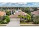 An elevated view showcases the home's well-maintained landscaping, three-car garage, and access to a beautiful lake at 16621 Berwick Ter, Lakewood Ranch, FL 34202