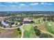 Aerial view of golf course and clubhouse, featuring manicured greens and views of the surrounding community at 16621 Berwick Ter, Lakewood Ranch, FL 34202