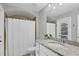 Well-lit bathroom with granite countertop, white cabinets, shower and tub combination, and toilet at 16621 Berwick Ter, Lakewood Ranch, FL 34202