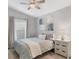 Cozy bedroom with neutral paint, ceiling fan, and brightly decorated dresser at 16621 Berwick Ter, Lakewood Ranch, FL 34202