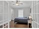 Cozy bedroom with hardwood floors, ceiling fan, neutral paint and abundant natural light at 16621 Berwick Ter, Lakewood Ranch, FL 34202