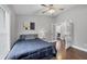 Bedroom with hardwood floors, a ceiling fan, and lots of natural light coming through the windows at 16621 Berwick Ter, Lakewood Ranch, FL 34202