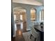Elegant dining room showcases arched doorways and hardwood floors leading to the living room at 16621 Berwick Ter, Lakewood Ranch, FL 34202