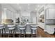 A well-equipped kitchen includes a spacious breakfast bar, stainless steel appliances, and crisp white cabinetry at 16621 Berwick Ter, Lakewood Ranch, FL 34202