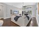 Spacious living room with a large sectional sofa, hardwood floors, and sliding glass doors to the lanai at 16621 Berwick Ter, Lakewood Ranch, FL 34202