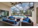Covered patio with a beautiful seating area and view of a pool and lush backyard at 16621 Berwick Ter, Lakewood Ranch, FL 34202