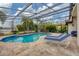 Screened pool with brick patio and two lounge chairs provides a relaxing backyard oasis at 16621 Berwick Ter, Lakewood Ranch, FL 34202