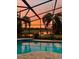 Enjoy stunning sunsets from the screened-in pool, with views of the tranquil lake and swaying palm trees at 16621 Berwick Ter, Lakewood Ranch, FL 34202