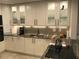 Updated kitchen featuring granite countertops, stainless steel appliances, and white cabinets at 2100 Benjamin Franklin Dr # 108, Sarasota, FL 34236
