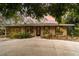 Inviting single-story home featuring lush landscaping, a screened in porch, and a spacious driveway at 2885 Arrowhead Rd, Venice, FL 34293
