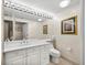 Bright bathroom features white vanity with framed mirror and artwork for a luxurious feel at 3060 Grand Bay Blvd # 113, Longboat Key, FL 34228