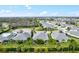 Residential aerial view showcasing a community layout with lush trees, waterways, and picturesque rooftops at 3922 Wildgrass Pl, Parrish, FL 34219