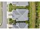 A top-down view of the home's roof, driveway, and surrounding lush landscaping of the property at 3922 Wildgrass Pl, Parrish, FL 34219