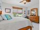 Cozy bedroom features a natural light window, soft bedding and wood furniture at 3922 Wildgrass Pl, Parrish, FL 34219