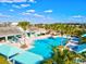 Aerial view of the large community pool area, complete with lounge chairs and lush landscaping at 3922 Wildgrass Pl, Parrish, FL 34219