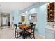 Cozy dining area with a wooden table, pendant lighting, and a view into the entryway at 3922 Wildgrass Pl, Parrish, FL 34219