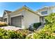 Charming home exterior showcasing a two-car garage, lush landscaping, and a welcoming walkway at 3922 Wildgrass Pl, Parrish, FL 34219