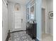Inviting foyer with decorative tile flooring, stylish decor, and a modern barn door feature at 3922 Wildgrass Pl, Parrish, FL 34219