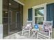 Relaxing front porch with rocking chairs, providing a cozy outdoor seating area at 3922 Wildgrass Pl, Parrish, FL 34219