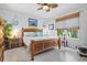 Serene main bedroom featuring a wooden bed frame, soft colors, and natural light from the window at 3922 Wildgrass Pl, Parrish, FL 34219