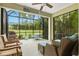 Screened in patio features comfortable seating and a barbecue for outdoor gatherings at 3922 Wildgrass Pl, Parrish, FL 34219