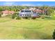 Aerial view showcasing a lush backyard overlooking the verdant golf course at 6170 Misty Oaks Dr, Sarasota, FL 34243