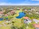 Community aerial showcasing golf course, lakes, and homes with mature landscaping at 6170 Misty Oaks Dr, Sarasota, FL 34243