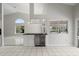 Modern bar area with a sleek countertop, a wine refrigerator, and bright tile floors, perfect for entertaining at 6170 Misty Oaks Dr, Sarasota, FL 34243