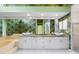 Bathroom featuring double sinks, granite countertops, white cabinets, decorative wall paper and oversized mirror at 6170 Misty Oaks Dr, Sarasota, FL 34243