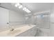 Well-lit bathroom featuring a double vanity, glass shower door, and tile flooring at 6170 Misty Oaks Dr, Sarasota, FL 34243