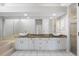 Bathroom with dual sinks and a mirrored wall at 6170 Misty Oaks Dr, Sarasota, FL 34243