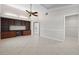 Light-filled bedroom with tile floors, vaulted ceilings, and a built-in desk and shelving unit at 6170 Misty Oaks Dr, Sarasota, FL 34243