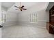 Spacious bedroom with vaulted ceiling, neutral walls, tile flooring, and built-in desk with shelving at 6170 Misty Oaks Dr, Sarasota, FL 34243