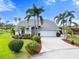 Beautiful single Gathering home with lush landscaping, a well-manicured lawn, and a paved driveway at 6170 Misty Oaks Dr, Sarasota, FL 34243