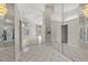 Expansive foyer with mirrored walls, decorative lighting, white tile floors, and views into adjacent living spaces at 6170 Misty Oaks Dr, Sarasota, FL 34243