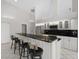 Open kitchen with bar seating, stainless appliances, and tile floors at 6170 Misty Oaks Dr, Sarasota, FL 34243