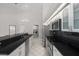 Modern kitchen with stainless appliances, black countertops, and white cabinets at 6170 Misty Oaks Dr, Sarasota, FL 34243