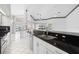 Kitchen with granite counter, modern appliances, white cabinets, leading to a relaxing outdoor pool at 6170 Misty Oaks Dr, Sarasota, FL 34243