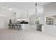 Bright and open living space with tile floors and bar, flowing to the kitchen at 6170 Misty Oaks Dr, Sarasota, FL 34243