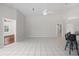 Spacious living room with bright tile flooring and a ceiling fan at 6170 Misty Oaks Dr, Sarasota, FL 34243