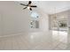 Bright living room with high ceilings, tile flooring, and large windows offering plenty of natural light at 6170 Misty Oaks Dr, Sarasota, FL 34243