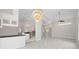 Open living space showcasing tile floors, modern lighting, and seamless flow into adjacent areas like the kitchen at 6170 Misty Oaks Dr, Sarasota, FL 34243