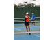 Action shot of a Personal playing pickleball on a well-maintained outdoor court at 6170 Misty Oaks Dr, Sarasota, FL 34243